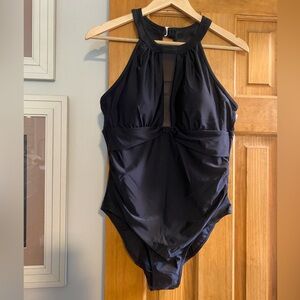 NWOT. Black halter style one piece with mesh inset.